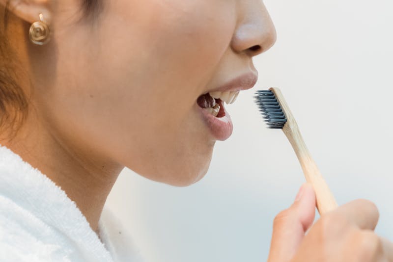 a woman brushing her teeth
